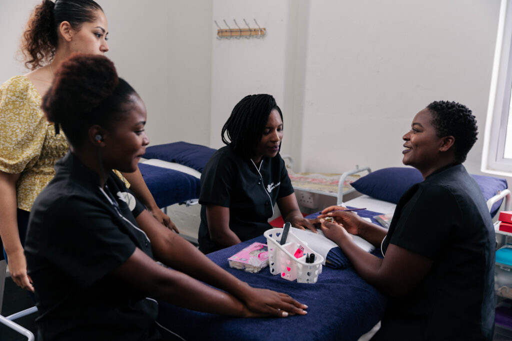 A group of students doing a nail technician course looking proffesionally dressed